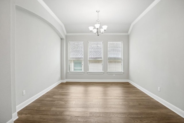 unfurnished room with ornamental molding, dark hardwood / wood-style flooring, vaulted ceiling, and a notable chandelier