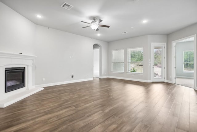 unfurnished living room with dark hardwood / wood-style floors and ceiling fan