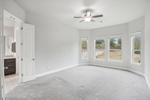 carpeted empty room with ceiling fan