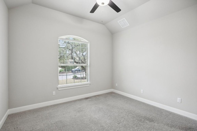 carpeted empty room with ceiling fan and lofted ceiling