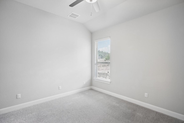 unfurnished room featuring ceiling fan, carpet floors, and vaulted ceiling