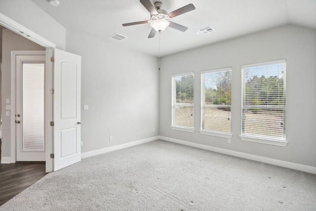 carpeted spare room with vaulted ceiling and ceiling fan