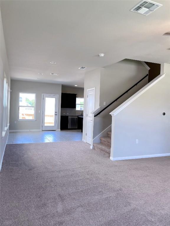 unfurnished living room with carpet floors