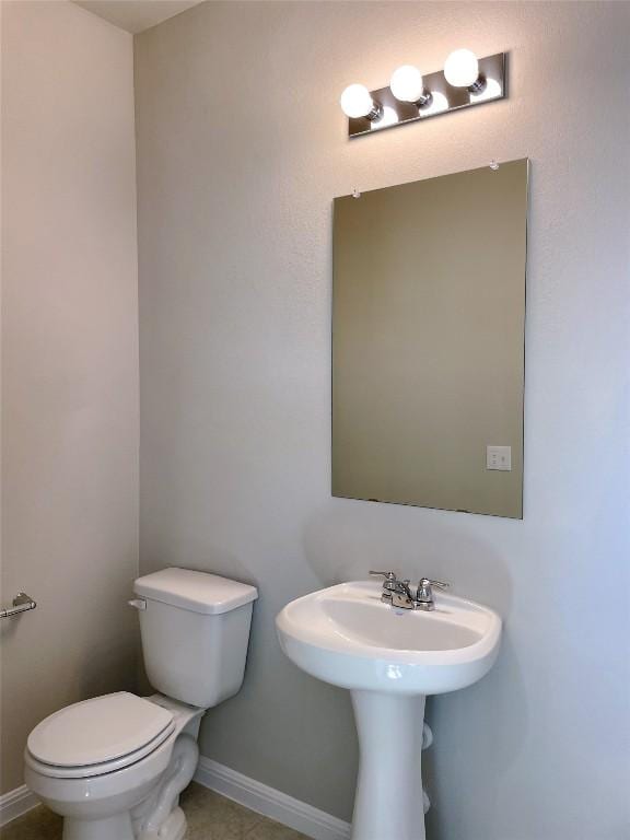 bathroom featuring tile patterned floors and toilet