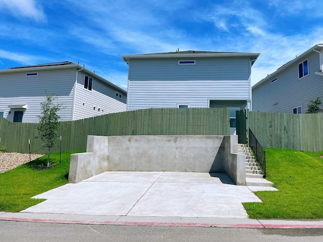 view of front of house featuring a patio area and a front lawn