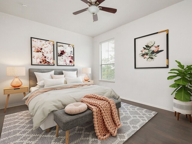 bedroom with dark hardwood / wood-style floors and ceiling fan