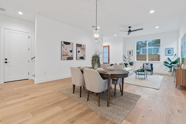 dining room with ceiling fan and light hardwood / wood-style flooring