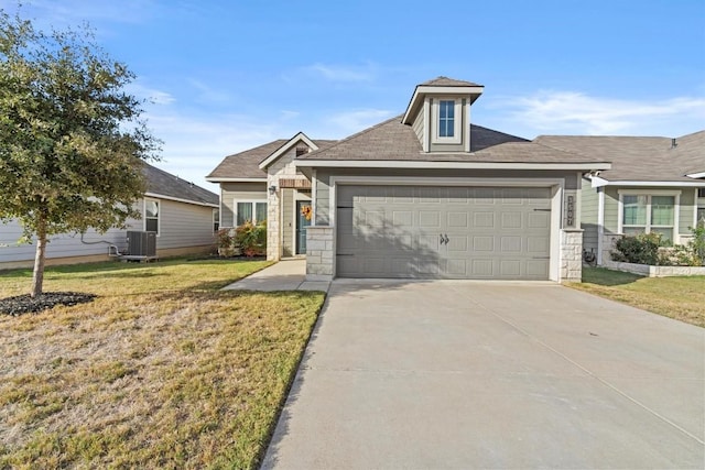 view of front facade with cooling unit, a garage, and a front lawn