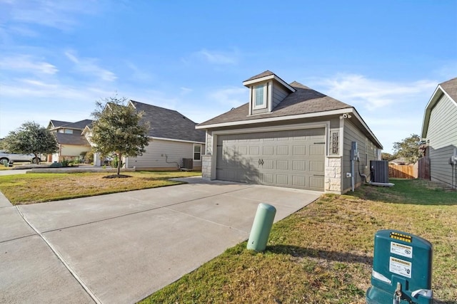 view of front of house with cooling unit, a garage, and a front lawn