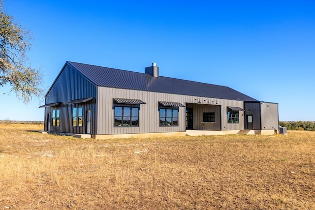 back of house featuring cooling unit