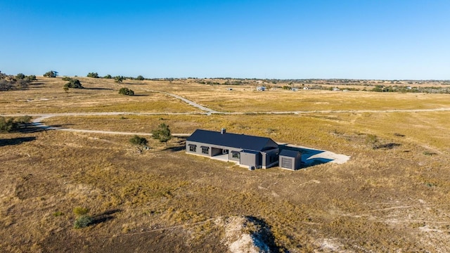 birds eye view of property with a rural view