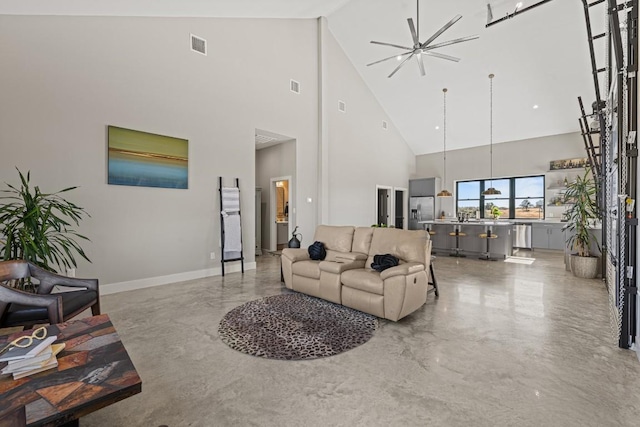 living room featuring a high ceiling and ceiling fan