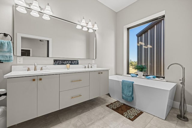 bathroom with vanity, tile patterned floors, and a bathing tub