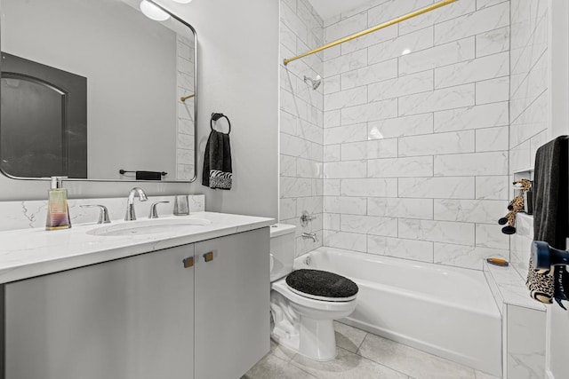 full bathroom featuring tile patterned flooring, vanity, toilet, and tiled shower / bath