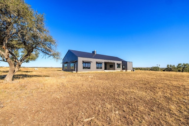 view of front facade with a rural view