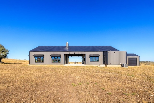 back of house with an outbuilding and a garage