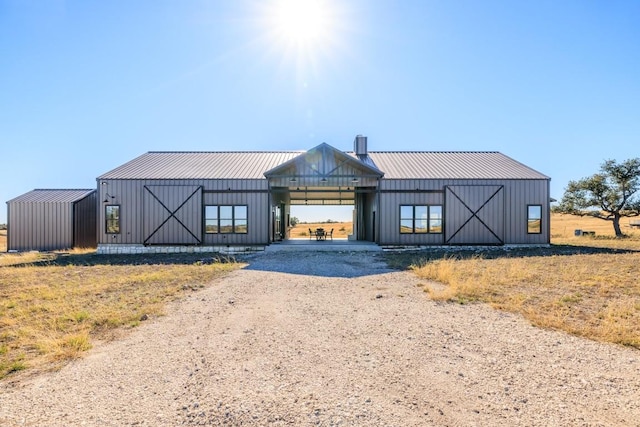 modern inspired farmhouse featuring an outbuilding