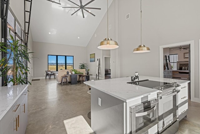 kitchen featuring pendant lighting, double oven range, white cabinetry, and high vaulted ceiling