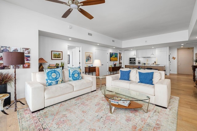 70 Rainey St Unit 1306, Austin, TX 78701 - living area featuring light wood finished floors, a ceiling fan, and recessed lighting
