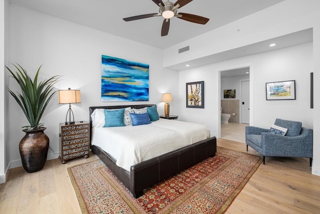 70 Rainey St Unit 1306, Austin, TX 78701 - bedroom featuring wood finished floors, recessed lighting, ensuite bathroom, a ceiling fan, and baseboards