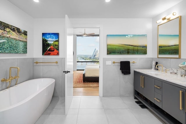 70 Rainey St Unit 1306, Austin, TX 78701 - full bathroom with a soaking tub, ensuite bathroom, double vanity, tile patterned floors, and recessed lighting