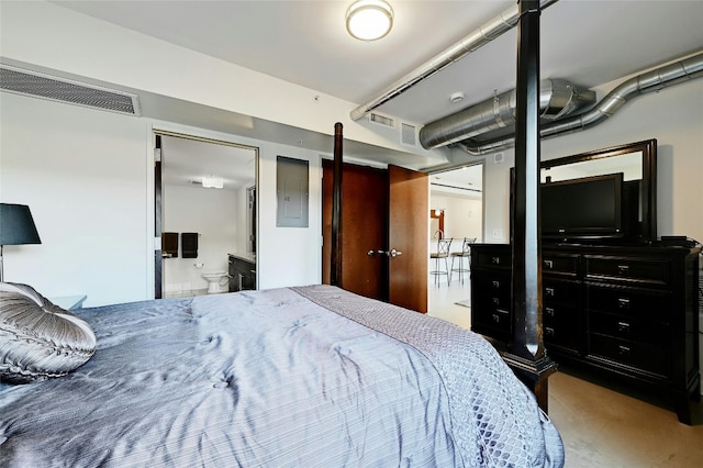 bedroom featuring ensuite bath and electric panel