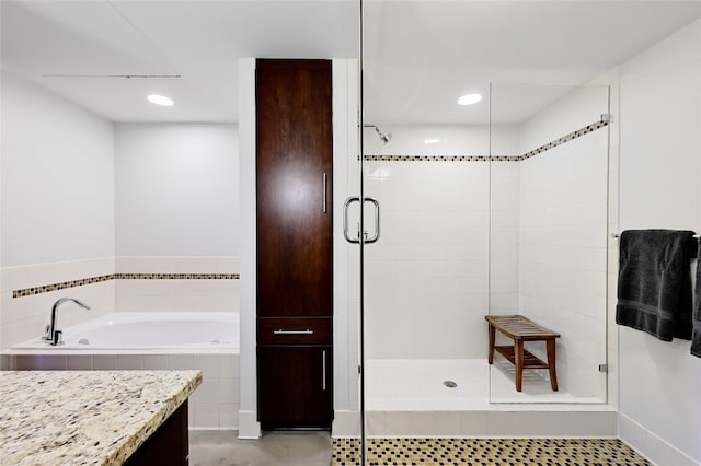 bathroom with independent shower and bath and tile patterned flooring