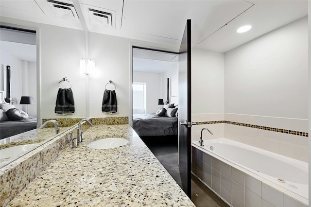 bathroom featuring vanity and tiled bath