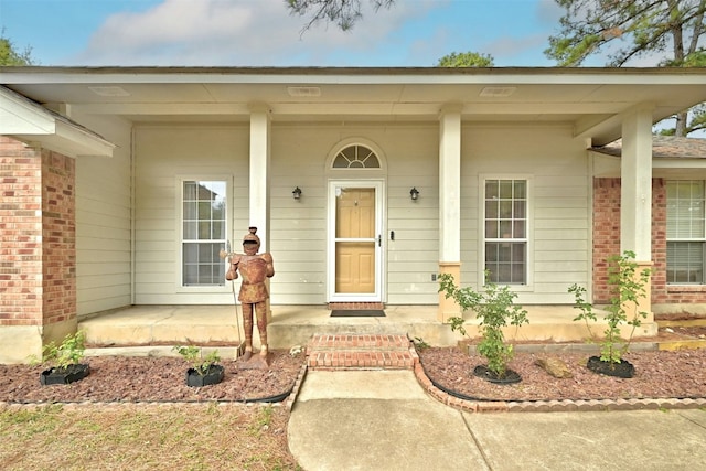 view of exterior entry with a porch