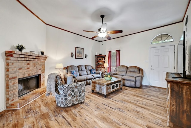 228 Old Firetower Rd, Bastrop, TX 78602 - living area with ornamental molding, light wood-type flooring, a ceiling fan, and a fireplace