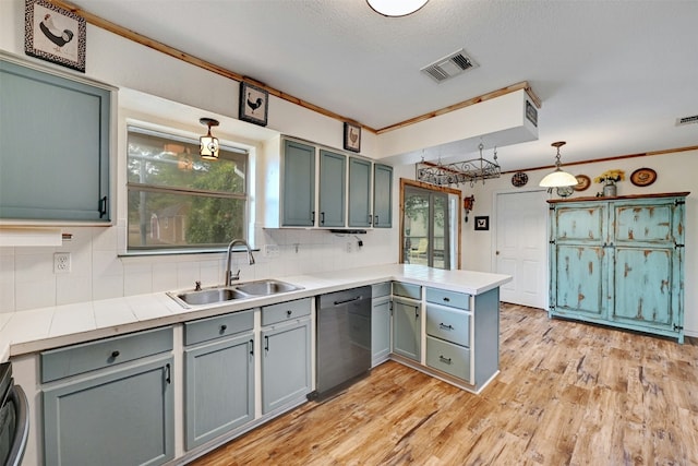 228 Old Firetower Rd, Bastrop, TX 78602 - kitchen featuring stainless steel dishwasher, a sink, a peninsula, tasteful backsplash, and light wood finished floors