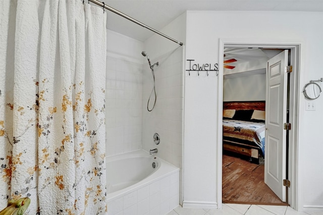 bathroom featuring shower / bath combo with shower curtain and tile patterned flooring