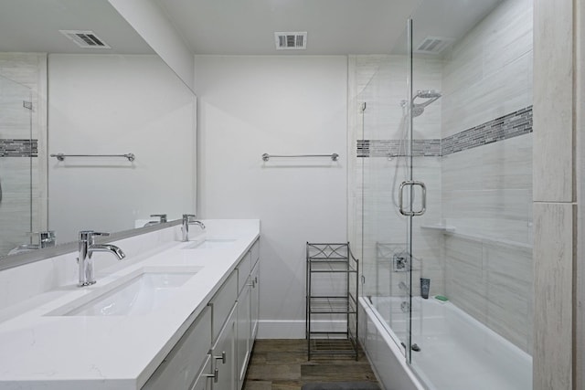 bathroom featuring shower / bath combination with glass door, wood-type flooring, and vanity