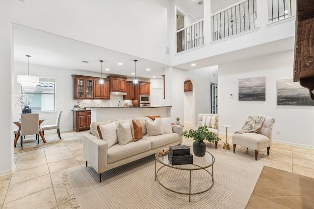 living room with light tile patterned floors and a high ceiling