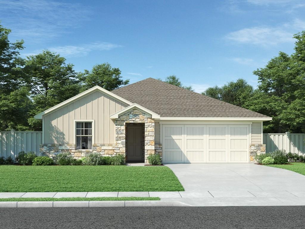 view of front of home featuring a garage and a front yard