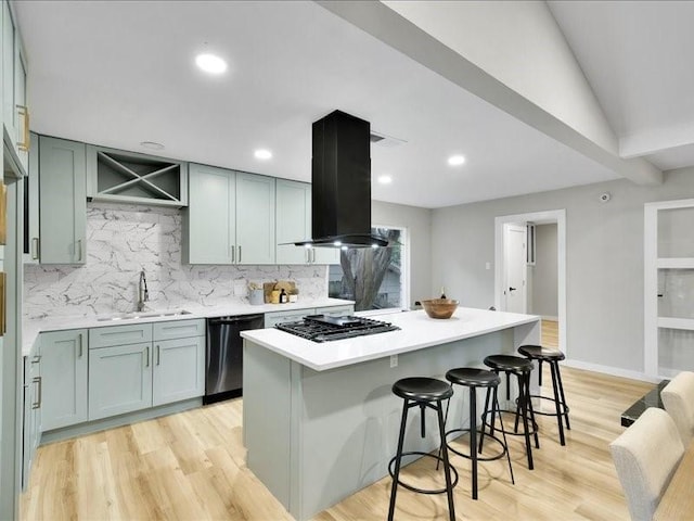 kitchen with appliances with stainless steel finishes, light hardwood / wood-style flooring, extractor fan, and sink