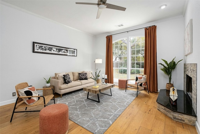 living room featuring ceiling fan, wood-type flooring, and ornamental molding