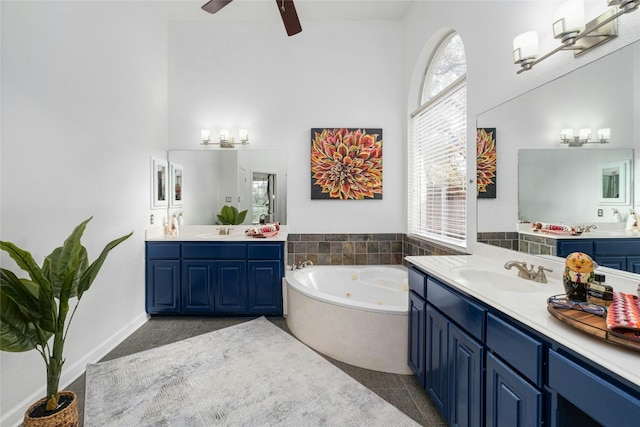 bathroom featuring a tub to relax in, tile patterned floors, vanity, and ceiling fan