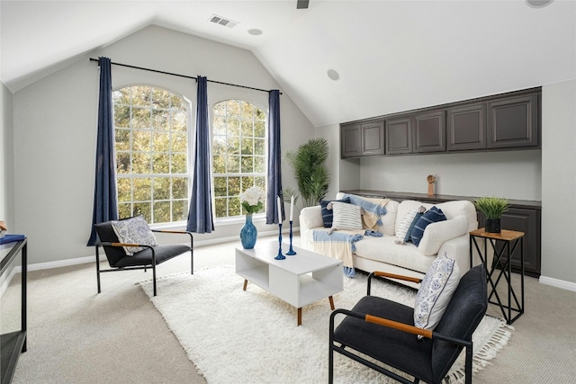 living room featuring light colored carpet and lofted ceiling