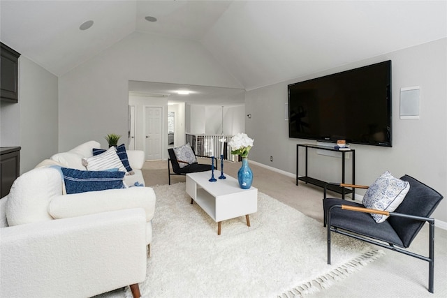 carpeted living room featuring vaulted ceiling