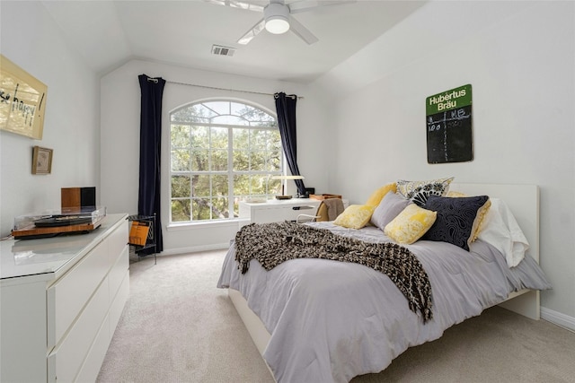 bedroom with ceiling fan, light colored carpet, and vaulted ceiling