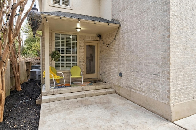 property entrance with central AC unit and a patio area