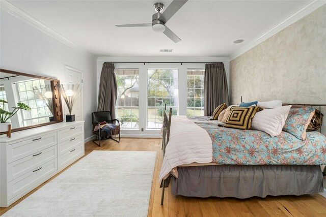 bedroom featuring ceiling fan, light hardwood / wood-style floors, and ornamental molding