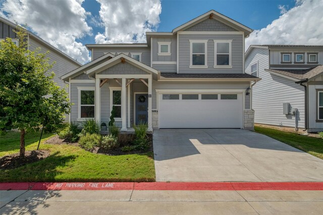 craftsman-style house with a garage and a front lawn