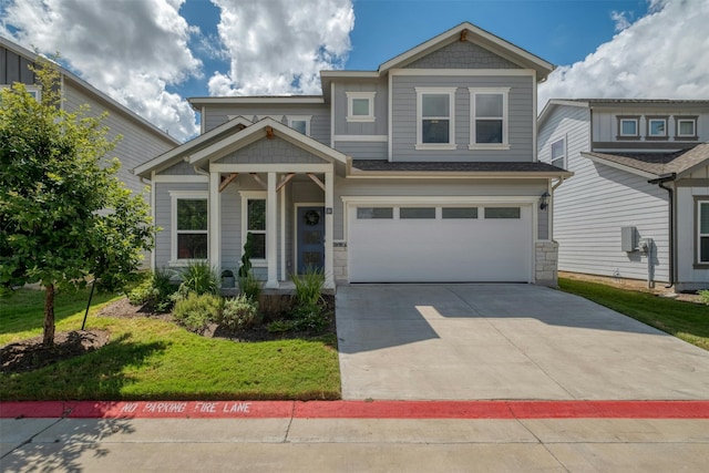 craftsman inspired home with a garage and a front yard