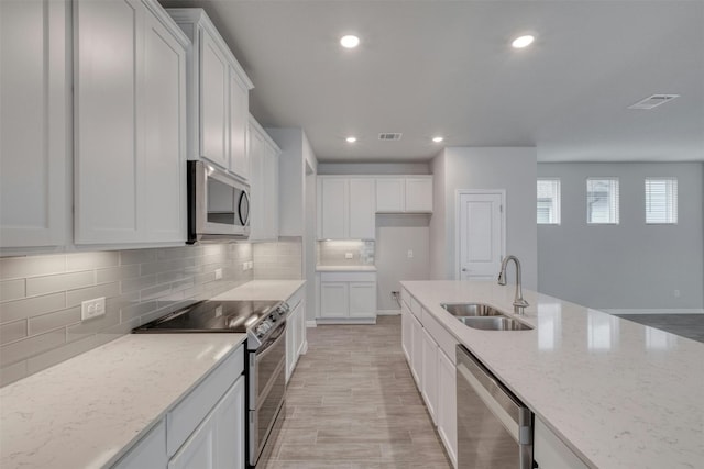 kitchen featuring white cabinetry, sink, and appliances with stainless steel finishes