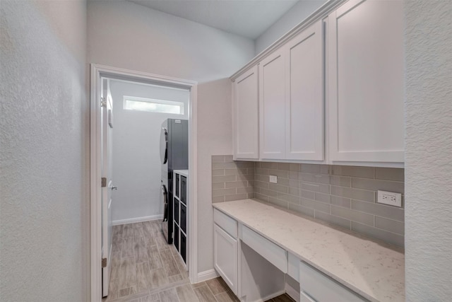 laundry area with stacked washer and dryer