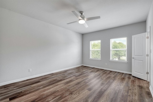 unfurnished room featuring dark hardwood / wood-style flooring and ceiling fan