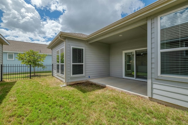 rear view of property with a lawn and a patio area