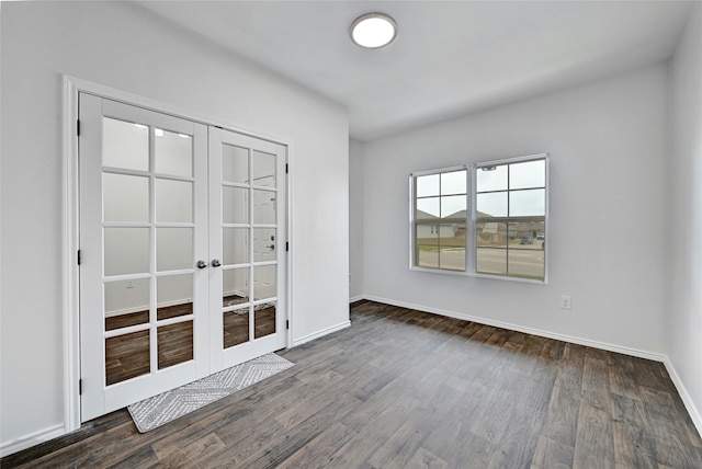 empty room featuring french doors and dark hardwood / wood-style floors